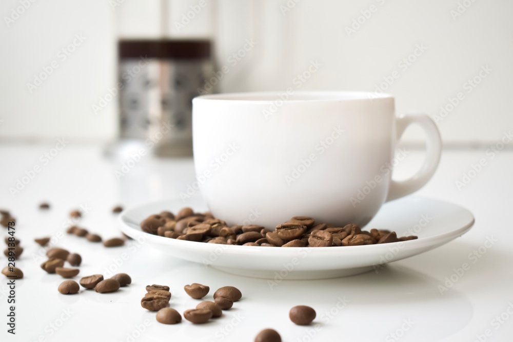 cup of coffee and beans on wooden background