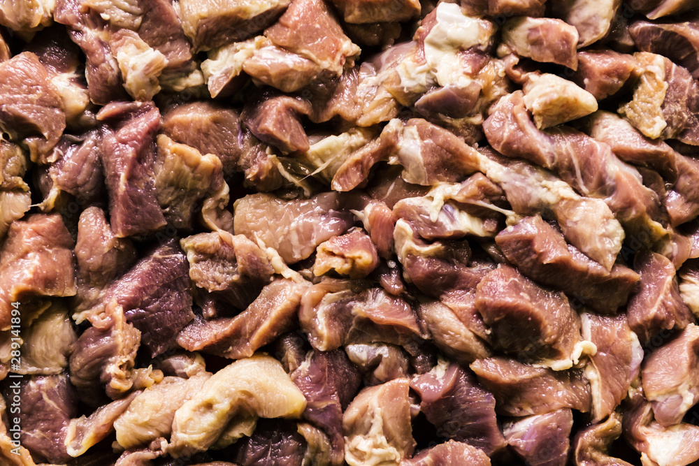 Heap of raw diced beef meat isolated, top view