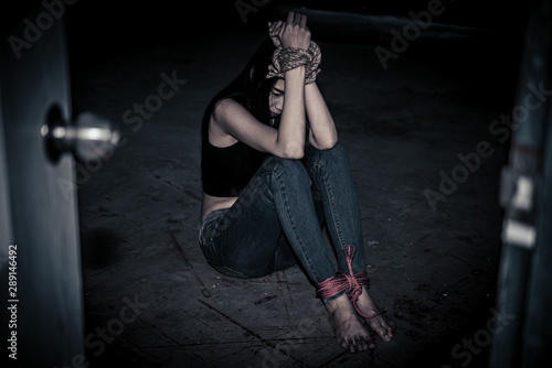 Asian hostage woman Bound with rope at night scene,The thieves kidnapped for ransom,thailand people