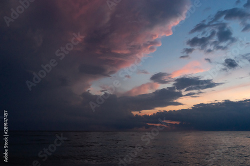 puesta de sol y tormenta aproximándose en el lago michigan photo