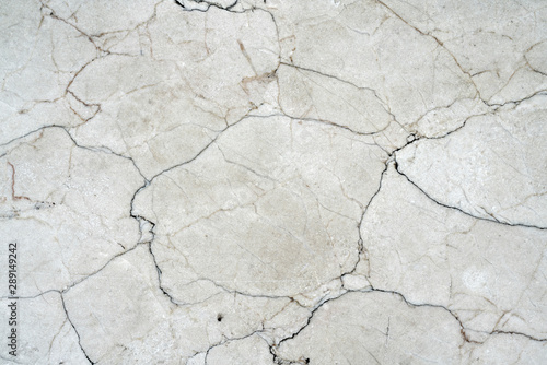 Cracks of gray marble. Wall of house. Construction industry.