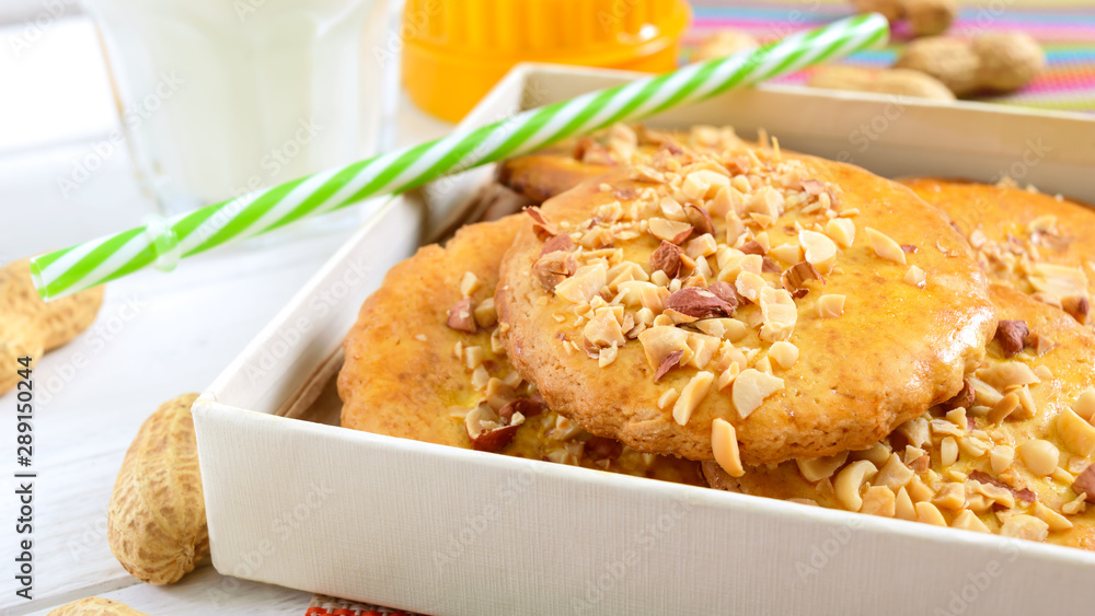 Shortbread dairy cookies with chopped nuts, milk and honey. Cookies in a box. Close up Shortbread dairy cookies with chopped nuts, milk and honey. Cookies in a box. Close up