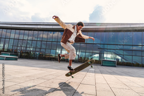 African american guy doing ollie with skateboard