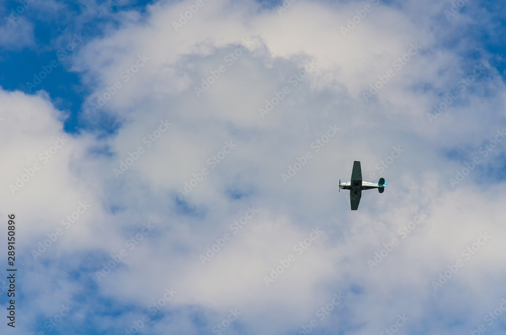 Small airplane flying in the sky with clouds Small airplane flying in the sky with clouds