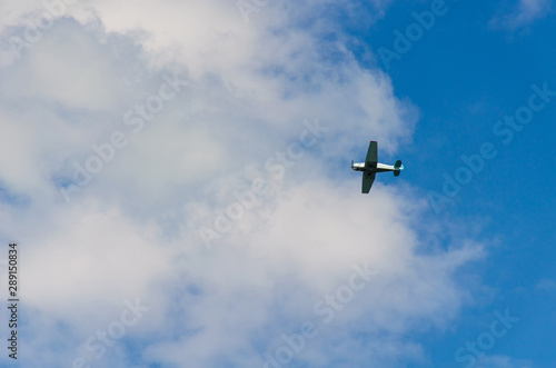 Fototapeta Naklejka Na Ścianę i Meble -  Small airplane flying in the sky with clouds