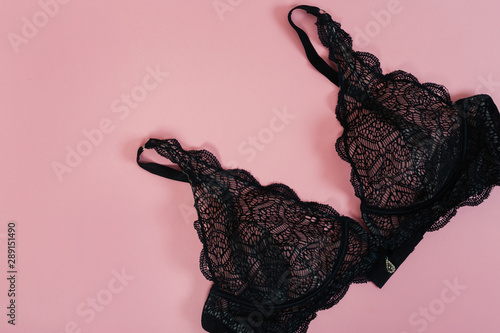 Black women underwear with lace on pink background. Copy space. Beauty, fashion blogger concept. Romantic lingerie for Valentine's day temptation.  photo