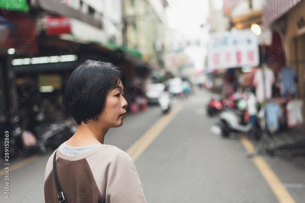 Asian woman walking on the street