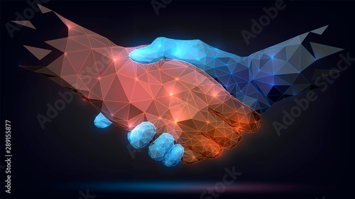 Two poligonal glowing hands, handshake, technology, business, trust concept photo