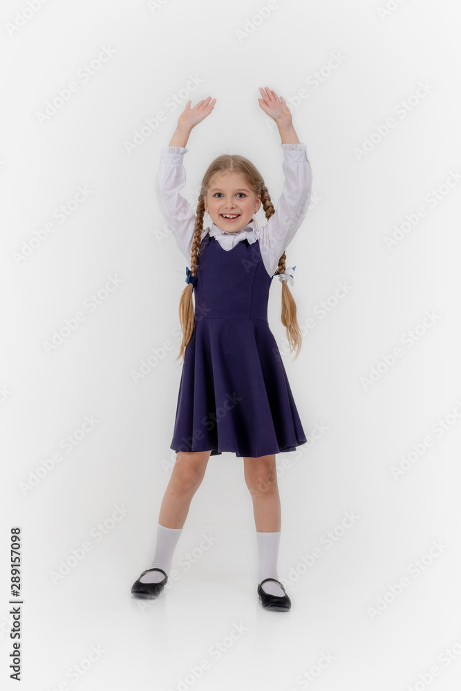 School girl posing for a picture cheerfully on white background School girl posing for a picture cheerfully on white background