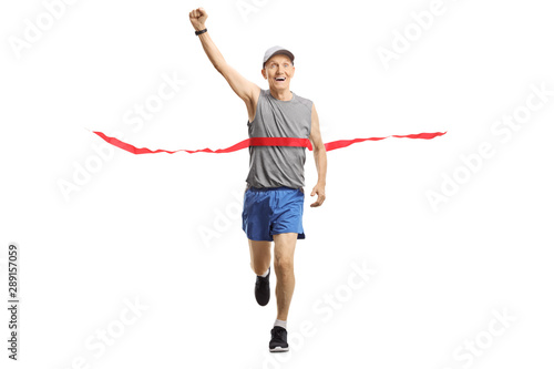 Senior man on the finish of a marathon gesturing happiness