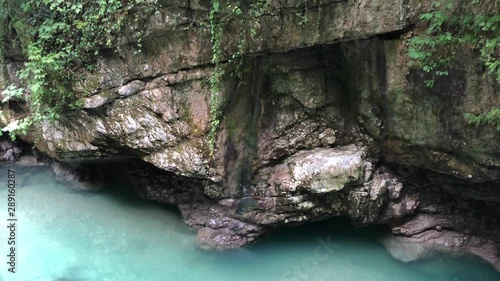 Martvili Canyon in Georgia. Turquoise water in a mountain river and cliffs of the reserve. Beautiful natural canyon, blue river water and green vegetation near Kutaisi. photo