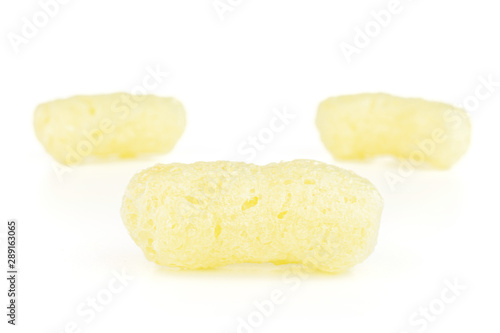 Group of three whole salted yellow corn puff isolated on white background