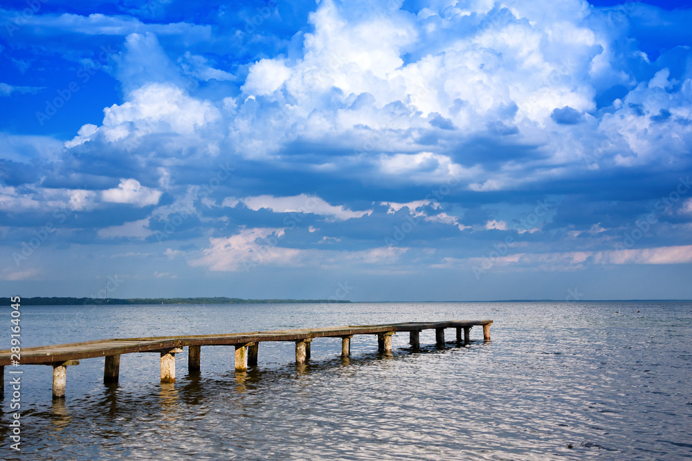 Panoramic sky over Naroch lake and pier. Belorussia