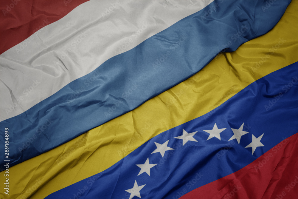 waving colorful flag of venezuela and national flag of luxembourg. waving colorful flag of venezuela and national flag of luxembourg.