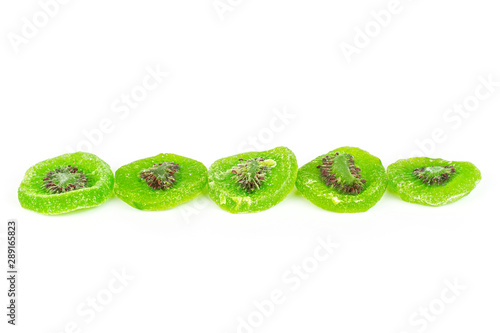 Group of five slices of sweet green candied kiwifruit in row isolated on white background