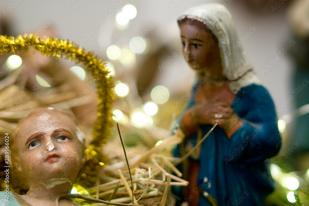Christmas nativity scene, old hand-painted plaster figurine, jesus in foreground, mary, religion, prayers, birth, christianity, holiday, lights, Italy