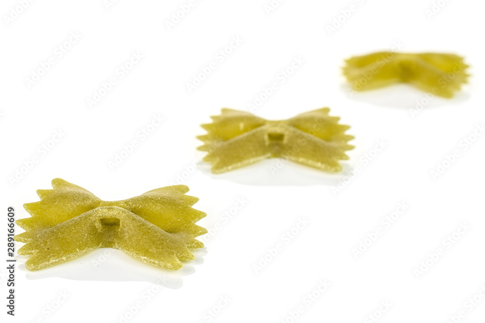 Group of three whole green uncooked farfalle isolated on white background Group of three whole green uncooked farfalle isolated on white background