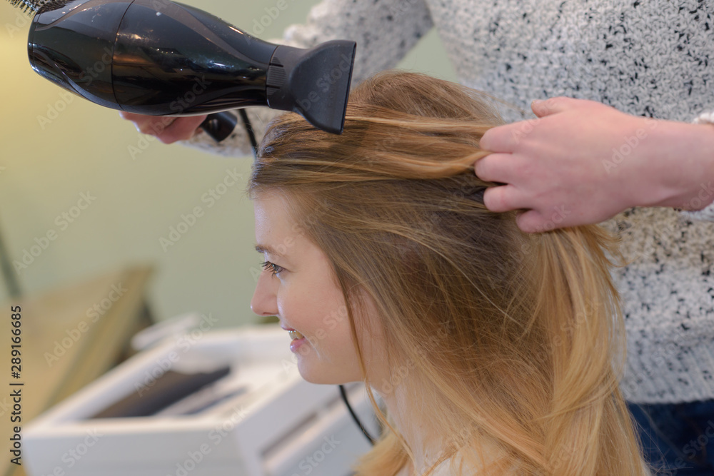 Fototapeta premium a hairdresser styling customers hair