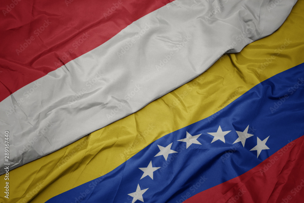 waving colorful flag of venezuela and national flag of indonesia. waving colorful flag of venezuela and national flag of indonesia.