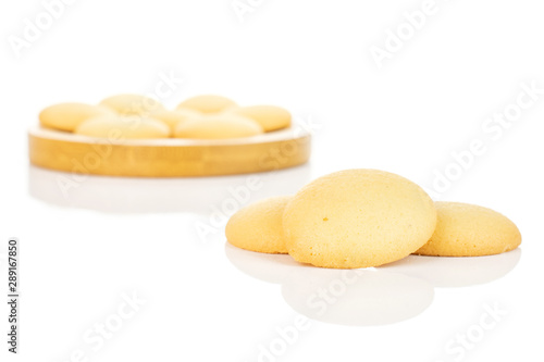 Murais de parede Group of ten whole sweet golden sponge biscuit on bamboo coaster isolated on whi