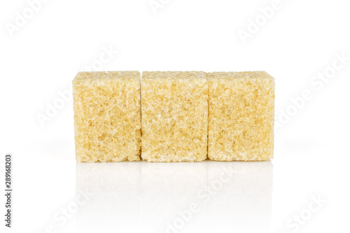 Group of three whole sweet brown sugar cube isolated on white background