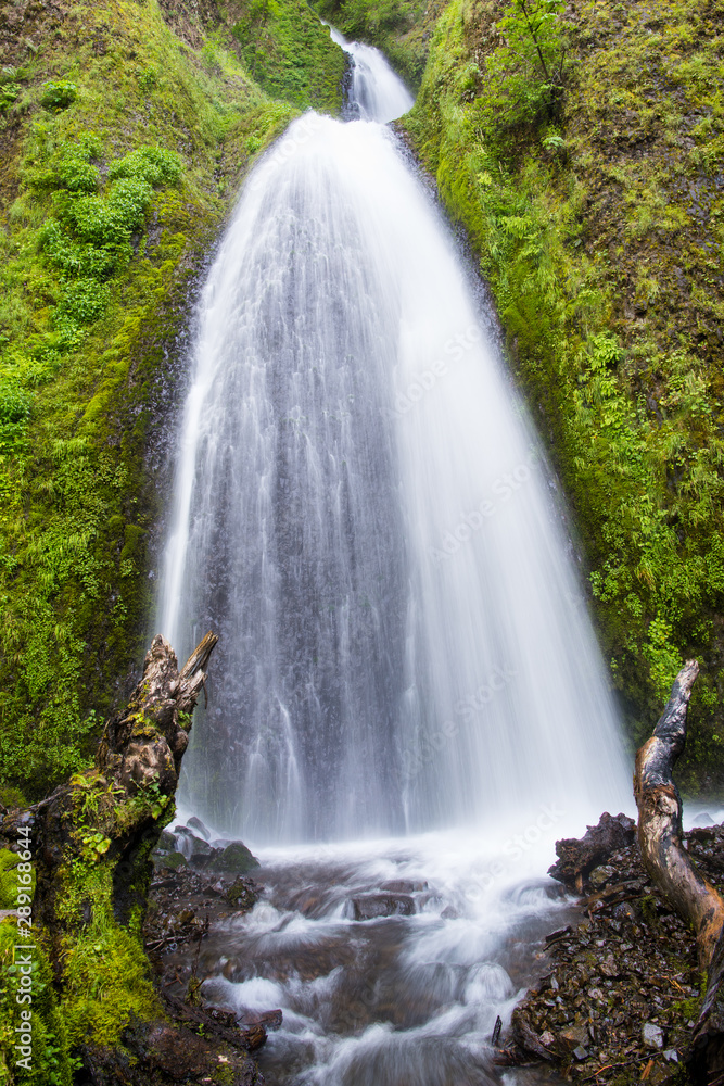 Waterfall flowing down moss covered cliffs - Wahkeena Falls in Oregon's Columbia River Gorge
