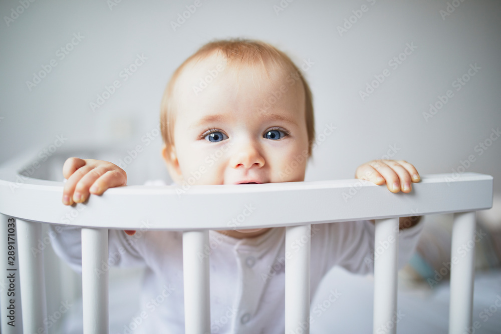 Adorable baby girl in co-sleeper crib Adorable baby girl in co-sleeper crib