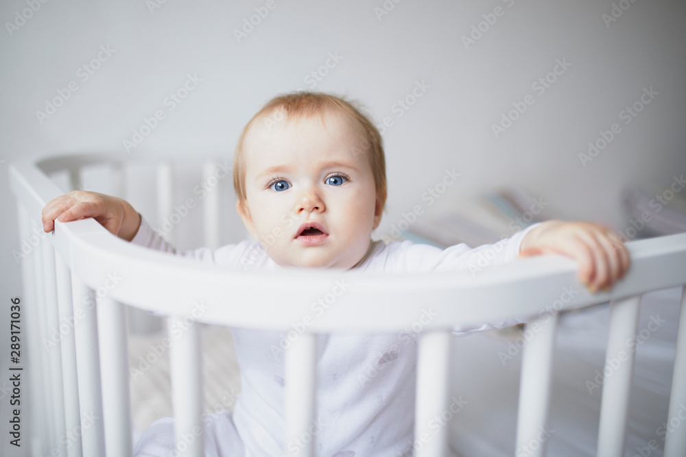 Adorable baby girl in co-sleeper crib Adorable baby girl in co-sleeper crib