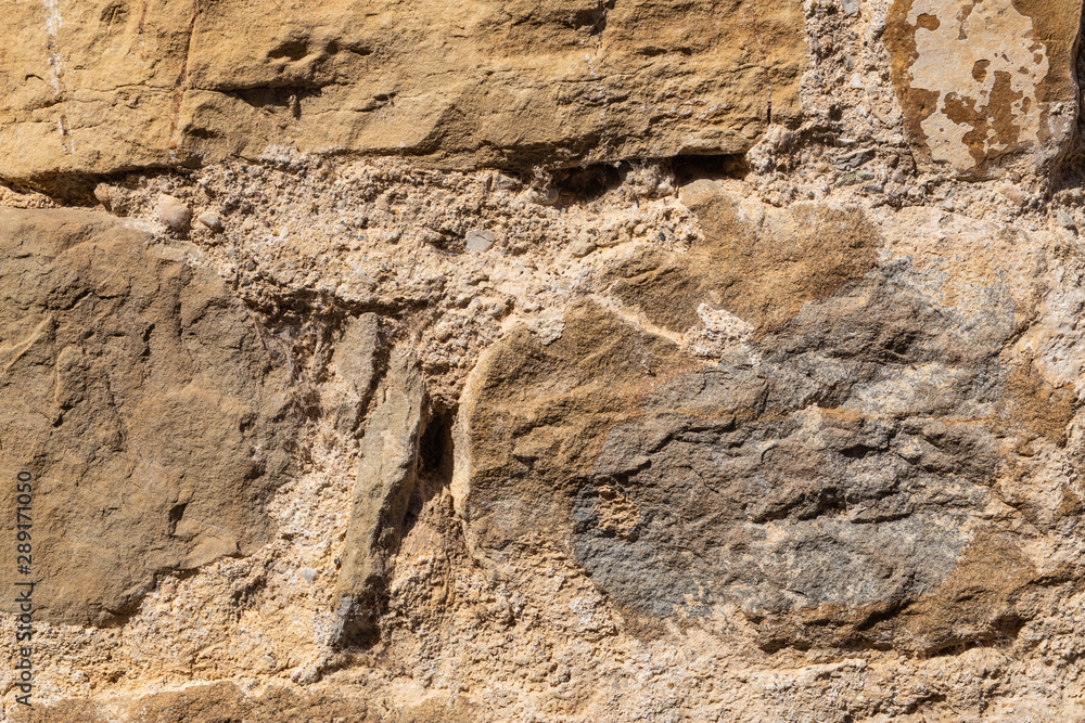 Natural background from a fragment of a stone wall of an old house