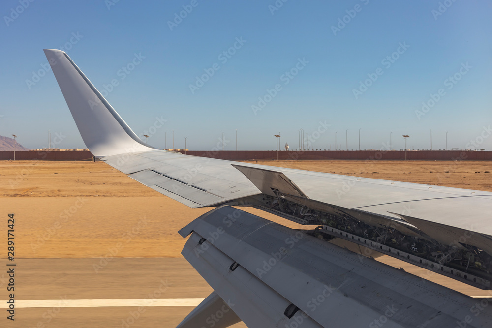 The plane lands on the airfield. Spoilers and flaps trailing edge when