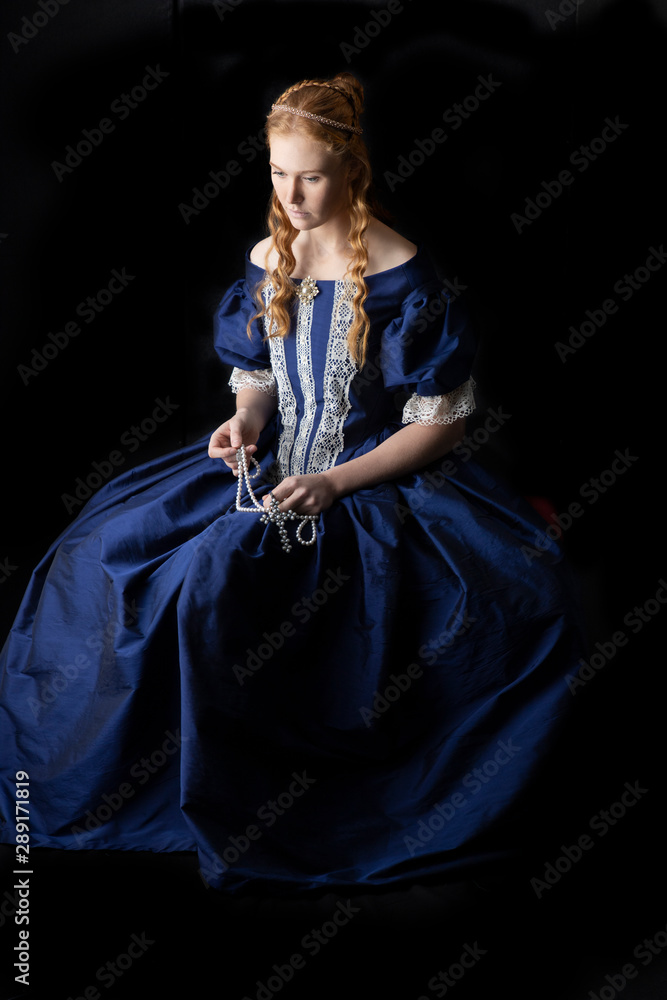 renaissance woman in a blue silk dress