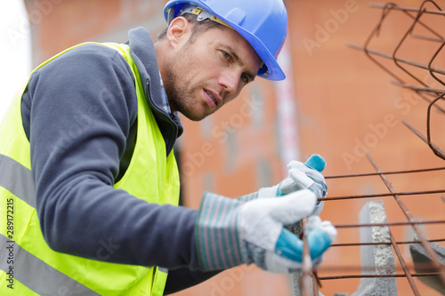 a male builder is working outdoors