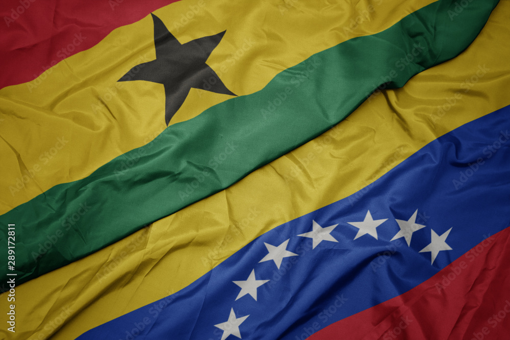 waving colorful flag of venezuela and national flag of ghana.