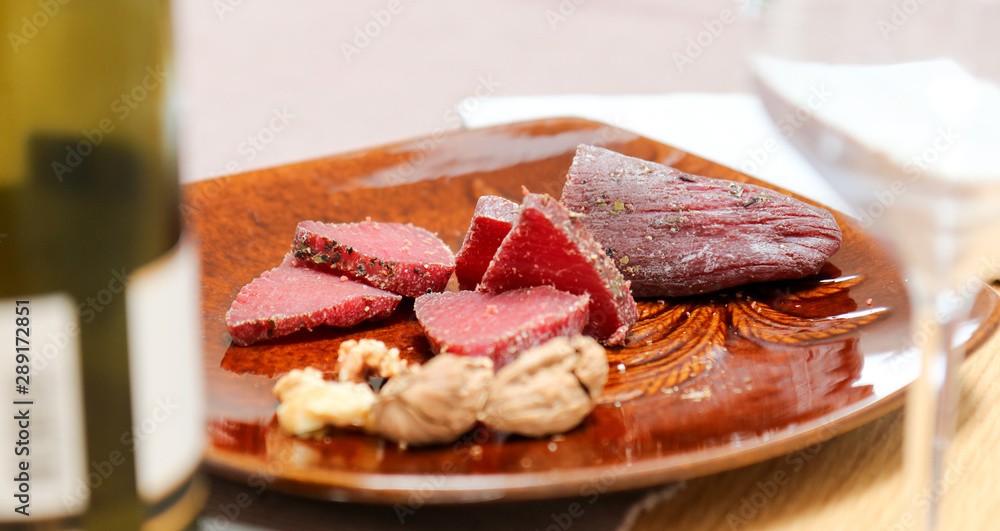Air cured beef served with nuts and red wine