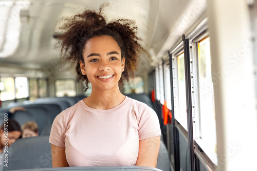 African girl sitting inside the school bus smiling cheerful close-up