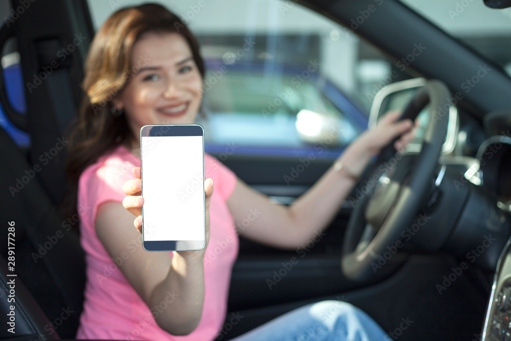 young woman driving car on the road
