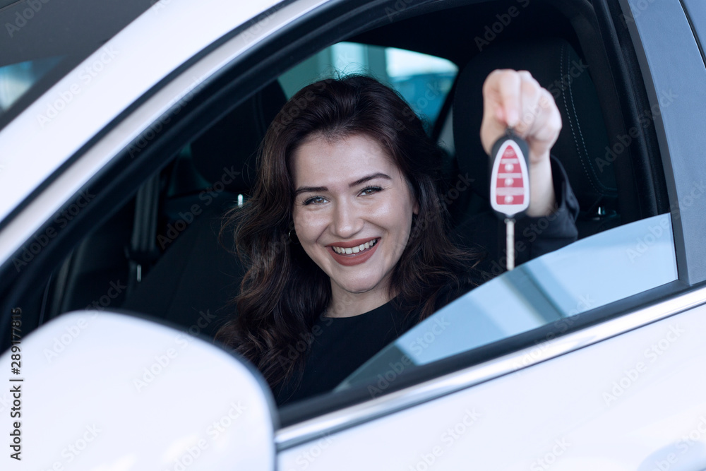 young woman driving car on the road