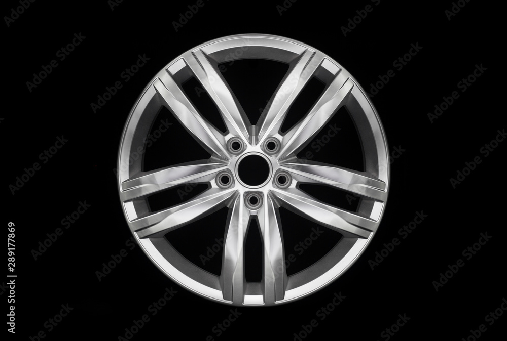 Modern car aluminium alloy wheel isolated on dark background