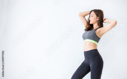 Canvas Print Portrait of beautiful healthy asian woman with sport wear copy space on white background
