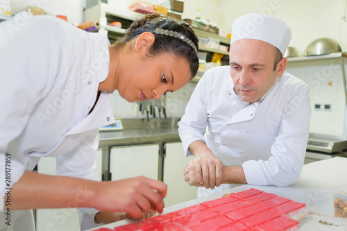 Photography cheerful girl at training school making cake