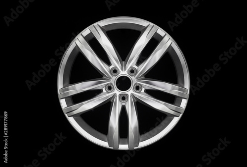 Modern car aluminium alloy wheel isolated on dark background © yursavieno