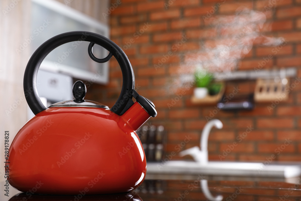 Modern kettle with whistle on stove in kitchen, space for text foto de  Stock | Adobe Stock