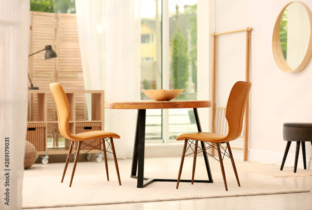 Modern dining room interior with table and chairs