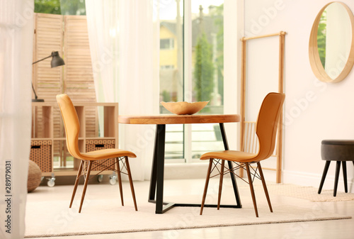 Modern dining room interior with table and chairs