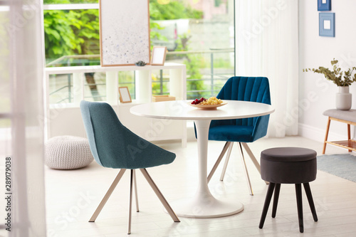 Modern dining room interior with table and chairs © New Africa