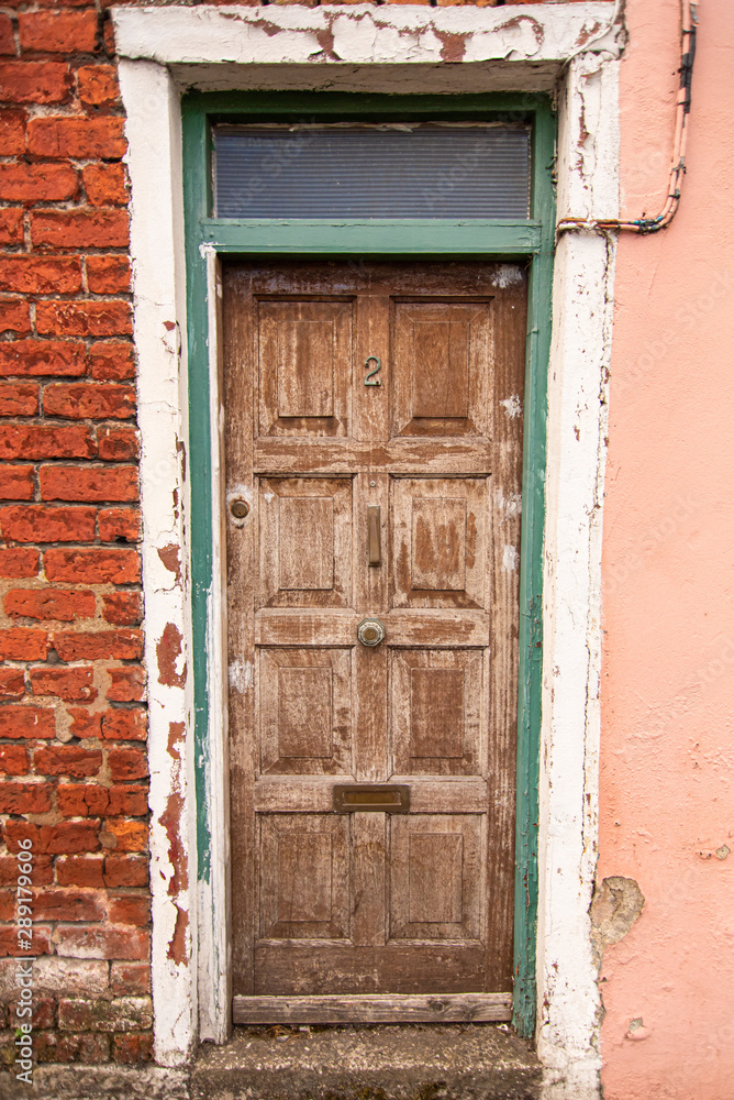 An old brown door in a building in Ireland