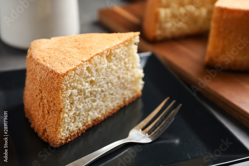 Piece of delicious fresh homemade cake served on grey table
