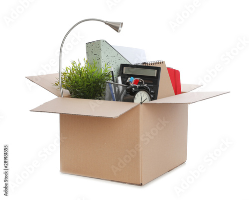 Vászonkép Cardboard box full of office stuff on white background