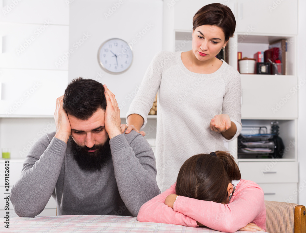 Fototapeta premium Mother lecturing husband and daughter
