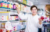 Happy pharmacist offering reliable medicine